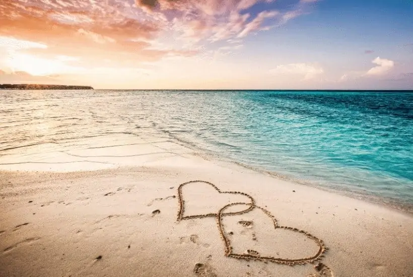 God Knows 9 Proven Ways To Guard Your Heart You Need To Know 3 an image of a beach scene to two hearts carved in the sand featured image for 9 Ways to Guard Your Heart Biblically